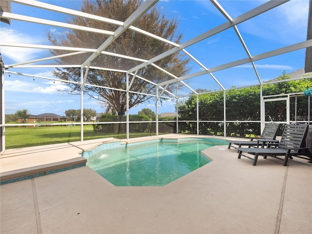 view of swimming pool featuring a patio and a lanai