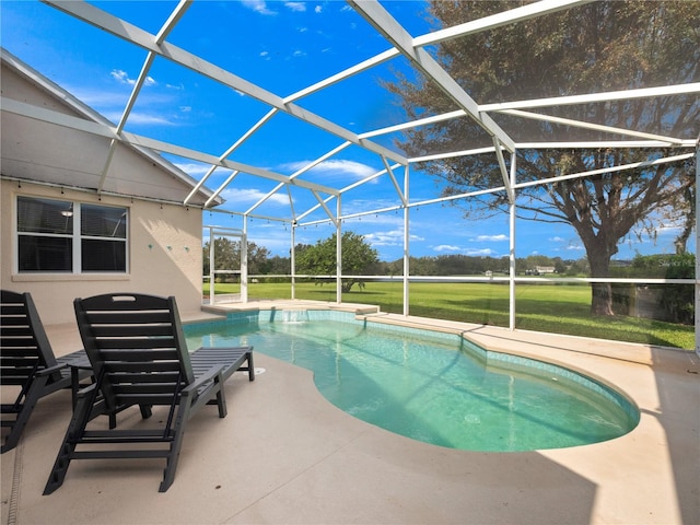 view of pool with a yard, a patio area, and a lanai