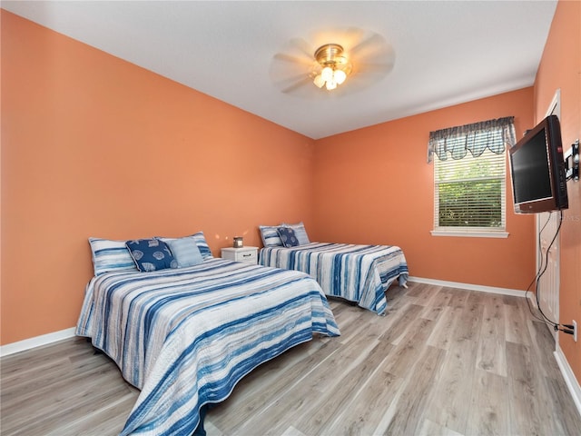 bedroom featuring light wood-type flooring and ceiling fan