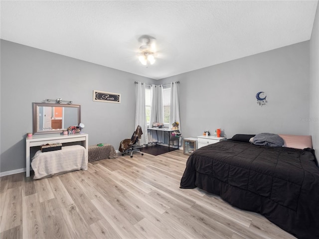 bedroom with ceiling fan and light hardwood / wood-style floors