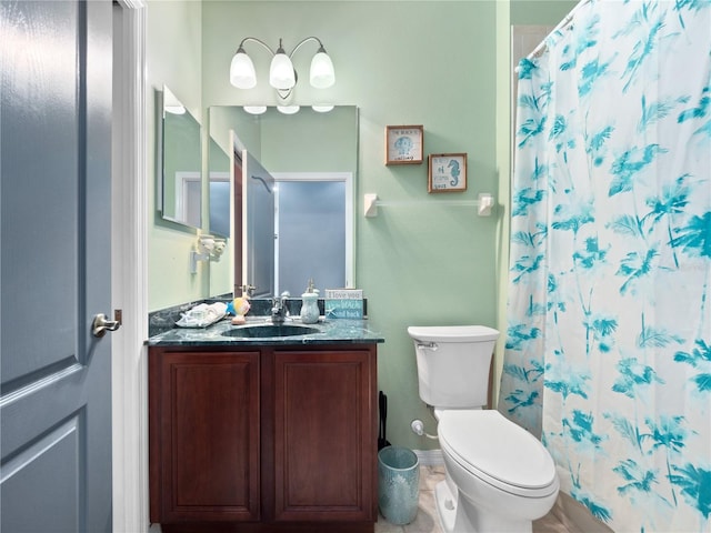 bathroom featuring toilet, vanity, and a shower with shower curtain