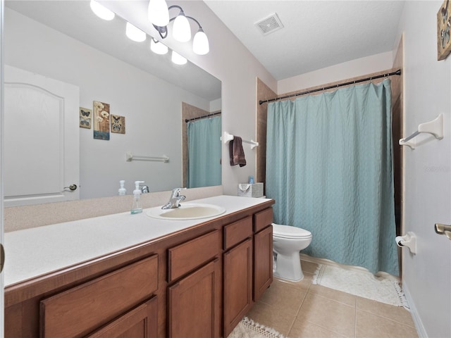 bathroom with toilet, tile patterned flooring, curtained shower, vanity, and a textured ceiling