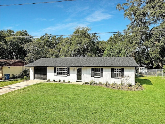 ranch-style house featuring a front yard and a garage