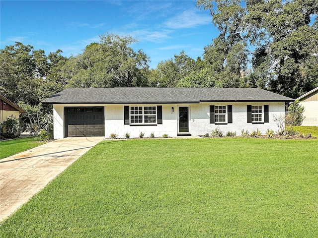 ranch-style home featuring a front lawn and a garage