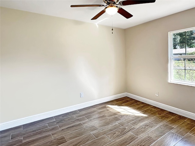 spare room featuring hardwood / wood-style flooring and ceiling fan