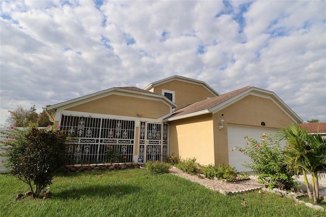 ranch-style home featuring a garage and a front lawn