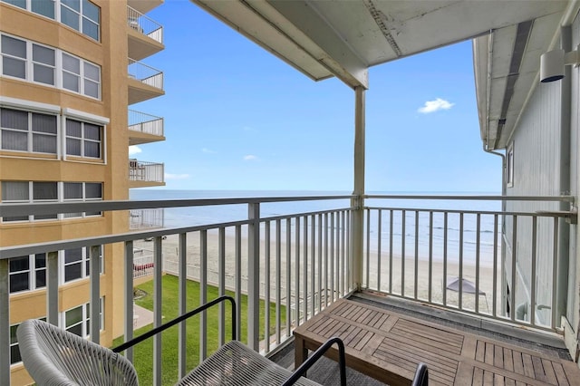 balcony featuring a beach view and a water view