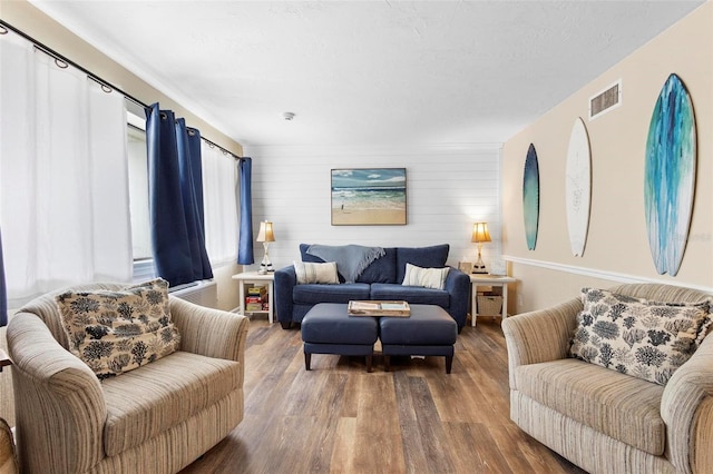 living room featuring wooden walls and wood-type flooring