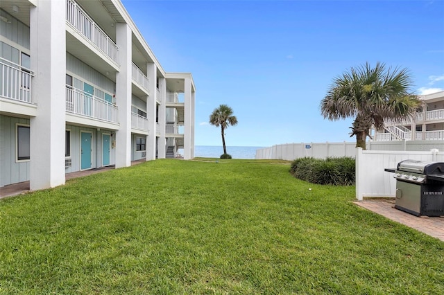 view of yard with a water view and a balcony