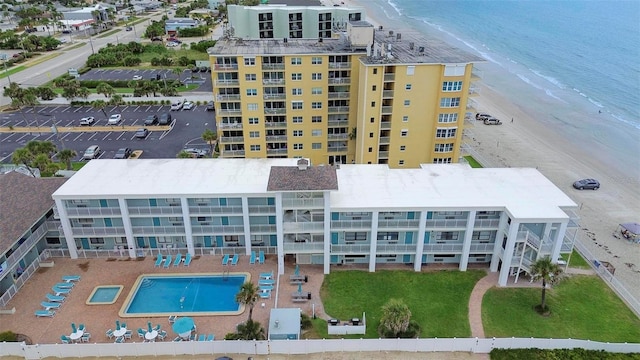 drone / aerial view with a beach view and a water view