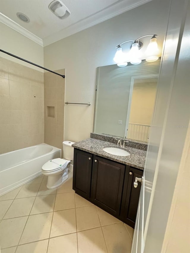 full bathroom featuring vanity, tile patterned floors, tiled shower / bath, toilet, and ornamental molding