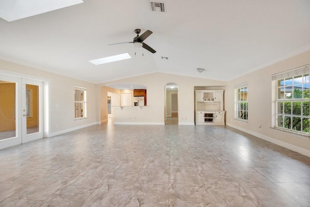 unfurnished living room featuring crown molding, lofted ceiling, and ceiling fan