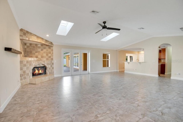 unfurnished living room featuring lofted ceiling, a fireplace, and crown molding