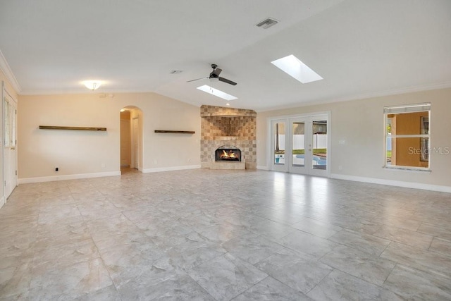 unfurnished living room with crown molding, lofted ceiling, a fireplace, and ceiling fan