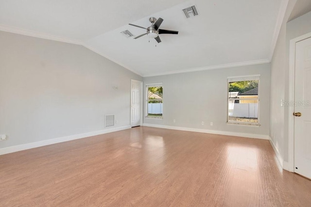 empty room with ceiling fan, ornamental molding, lofted ceiling, and light wood-type flooring