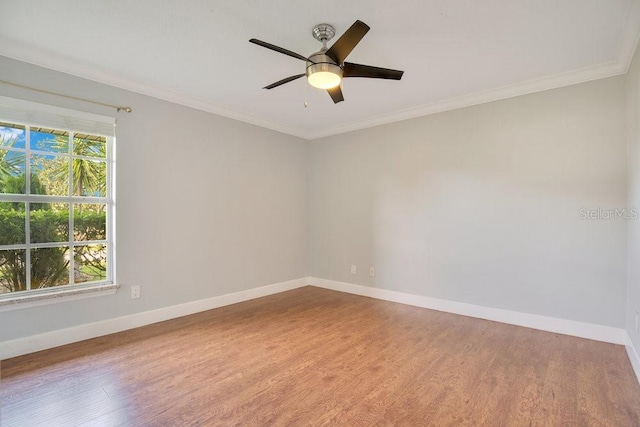 spare room featuring hardwood / wood-style floors, crown molding, and ceiling fan