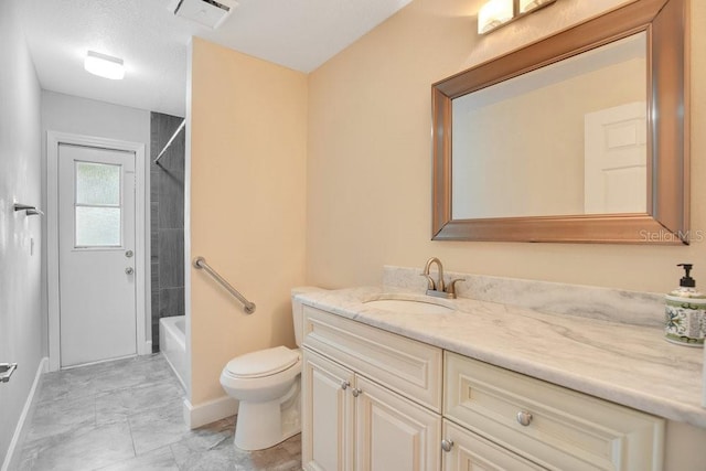 full bathroom featuring a textured ceiling, toilet, vanity, tiled shower / bath combo, and tile patterned floors