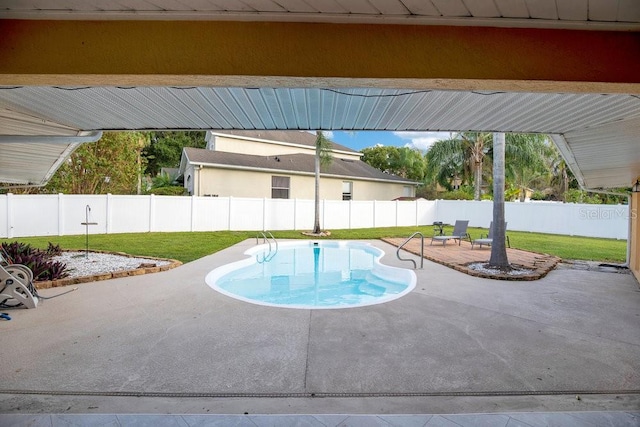 view of swimming pool featuring a yard and a patio