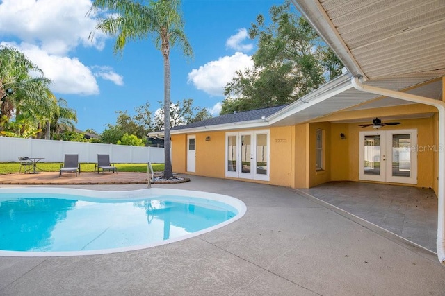 view of swimming pool featuring french doors, a patio area, and ceiling fan