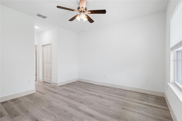 spare room featuring light hardwood / wood-style flooring and ceiling fan