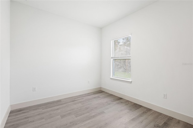 spare room with light hardwood / wood-style flooring