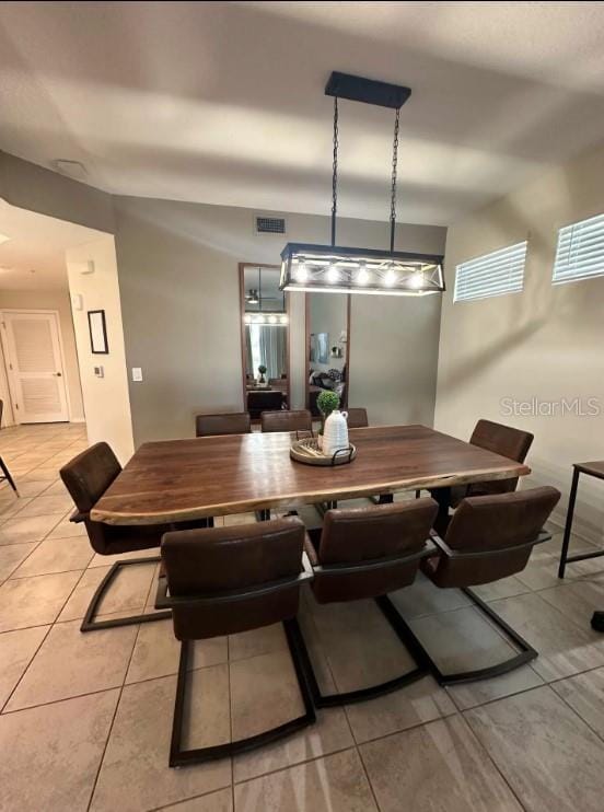 dining space with light tile patterned floors