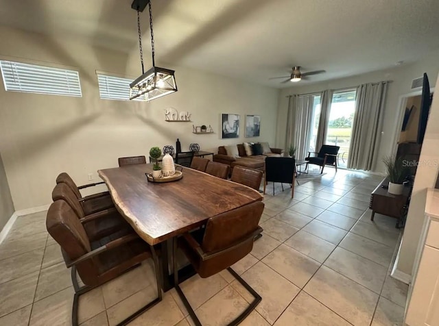 tiled dining room featuring ceiling fan