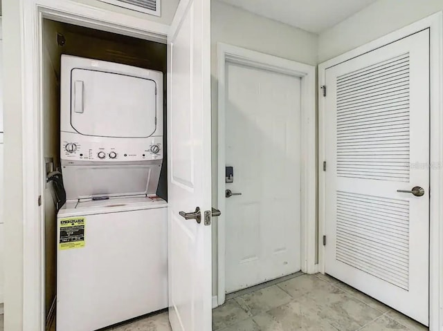 laundry room with stacked washer / drying machine