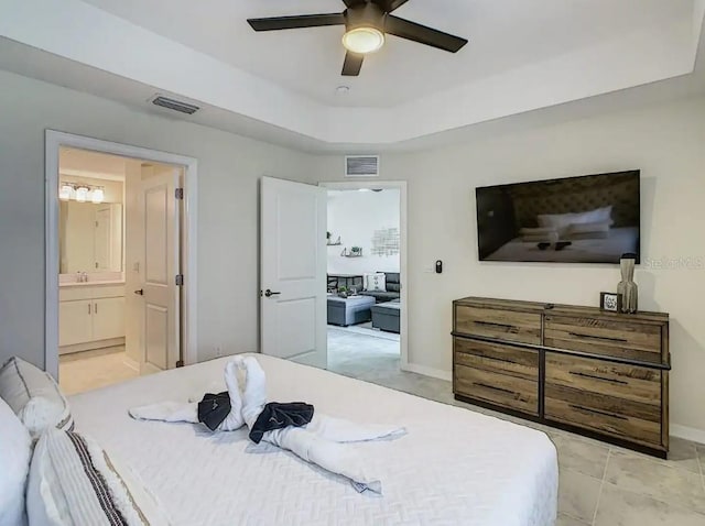 tiled bedroom featuring ceiling fan and ensuite bath