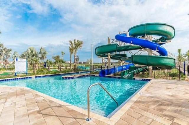 view of pool featuring a patio and a water slide