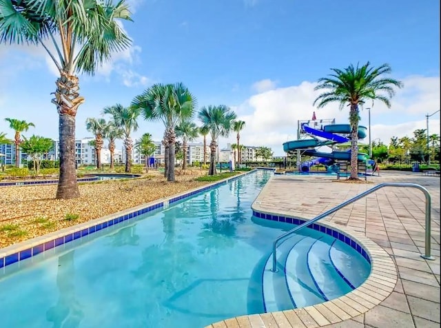 view of pool with a water slide