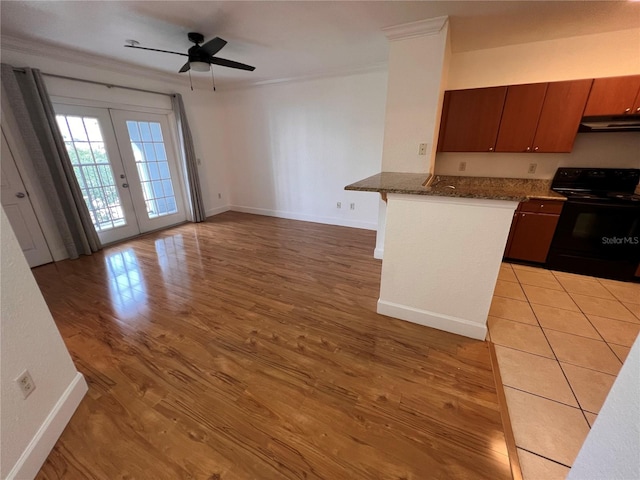 kitchen with french doors, ceiling fan, electric range, and light wood-type flooring