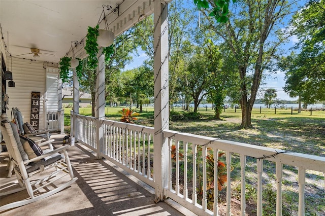 balcony with covered porch and ceiling fan