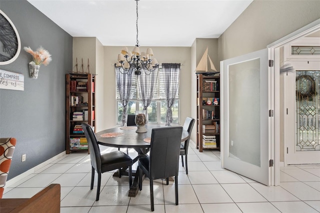 dining room with an inviting chandelier and light tile patterned floors