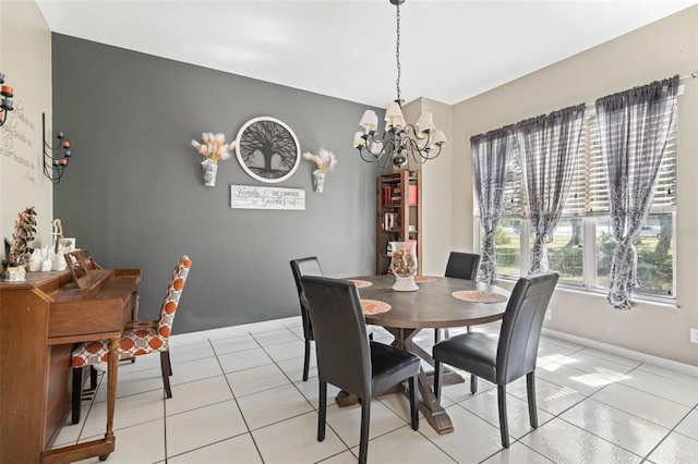 dining space with light tile patterned floors and a chandelier