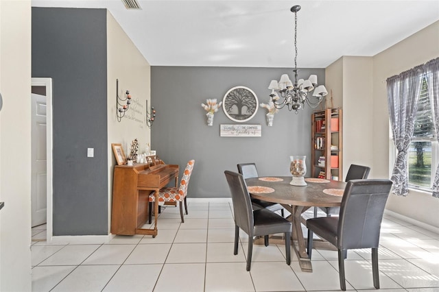 tiled dining room featuring a wealth of natural light and a chandelier