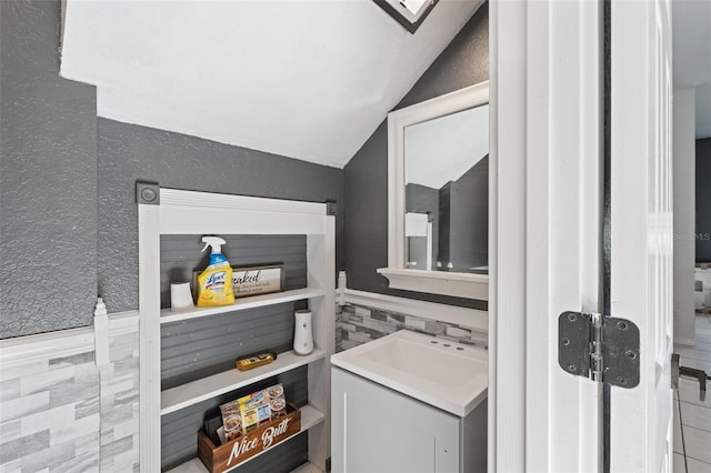 bathroom featuring vanity and vaulted ceiling