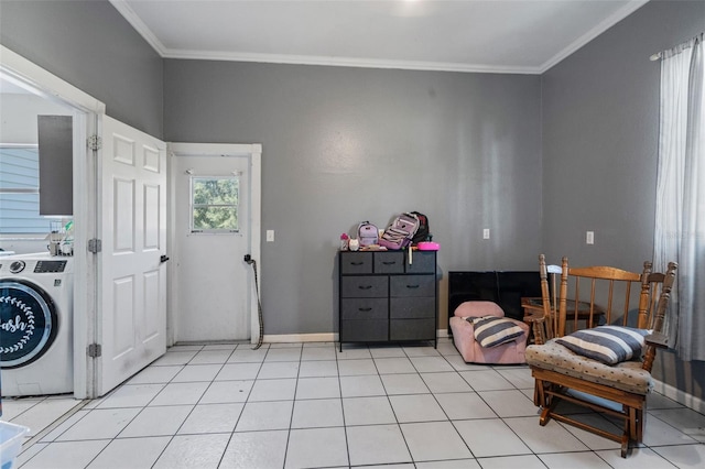 sitting room featuring washer / dryer, ornamental molding, and light tile patterned floors