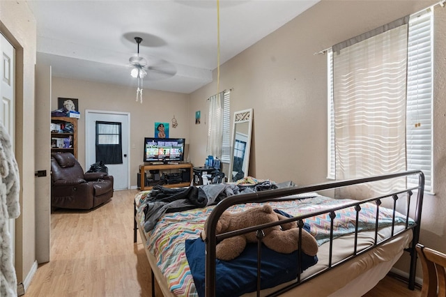 bedroom with light hardwood / wood-style flooring and ceiling fan