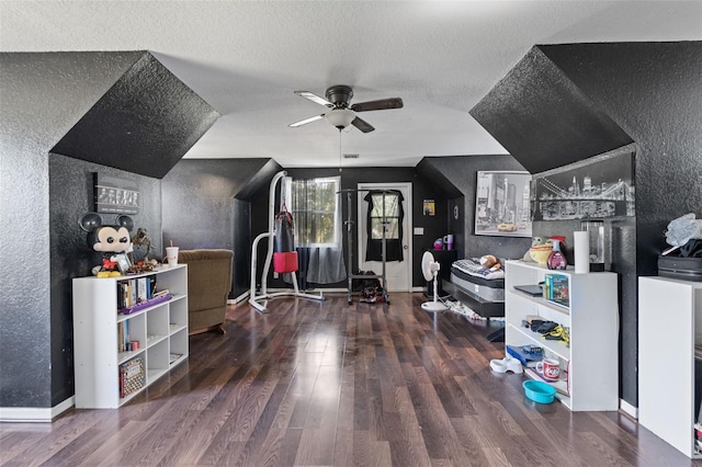 interior space with ceiling fan, a textured ceiling, and dark hardwood / wood-style floors