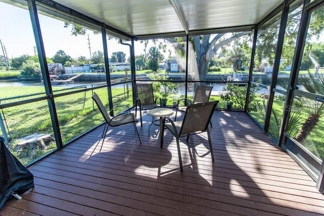 unfurnished sunroom with a water view