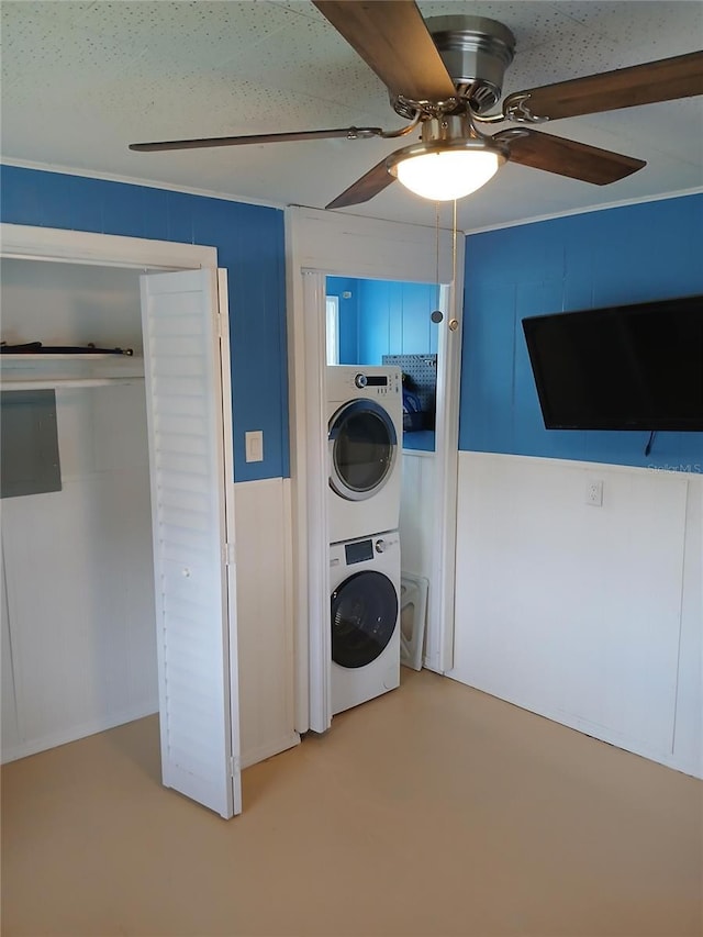 laundry room featuring ceiling fan and stacked washer and clothes dryer