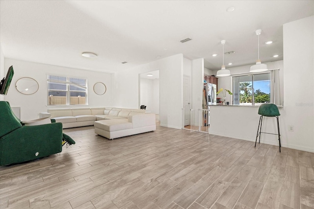 living room with light hardwood / wood-style flooring