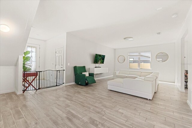1909 Cayman Cove Cir, Saint Cloud, FL 34772 - living area featuring light wood-style flooring, baseboards, and plenty of natural light