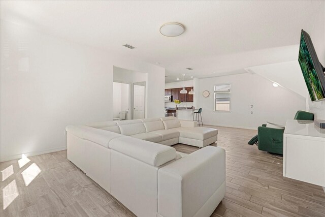 1909 Cayman Cove Cir, Saint Cloud, FL 34772 - living room featuring visible vents and light wood-style floors