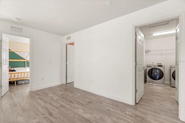 1909 Cayman Cove Cir, Saint Cloud, FL 34772 - laundry room featuring laundry area, visible vents, light wood-style floors, separate washer and dryer, and attic access