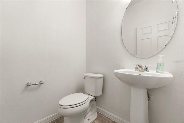 1909 Cayman Cove Cir, Saint Cloud, FL 34772 - half bath with wood finished floors, baseboards, and toilet