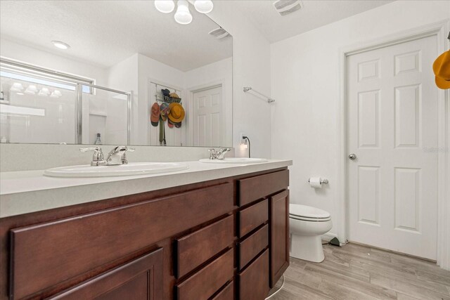 1909 Cayman Cove Cir, Saint Cloud, FL 34772 - full bath featuring wood finished floors, a sink, a shower stall, and toilet