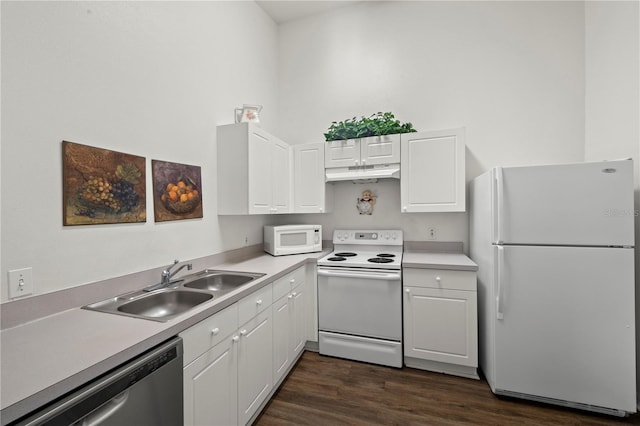 kitchen with white appliances, white cabinets, sink, and dark hardwood / wood-style flooring