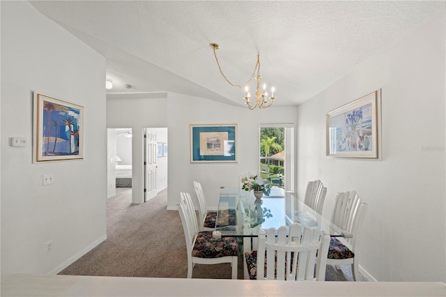 dining area featuring light carpet, a textured ceiling, and a chandelier